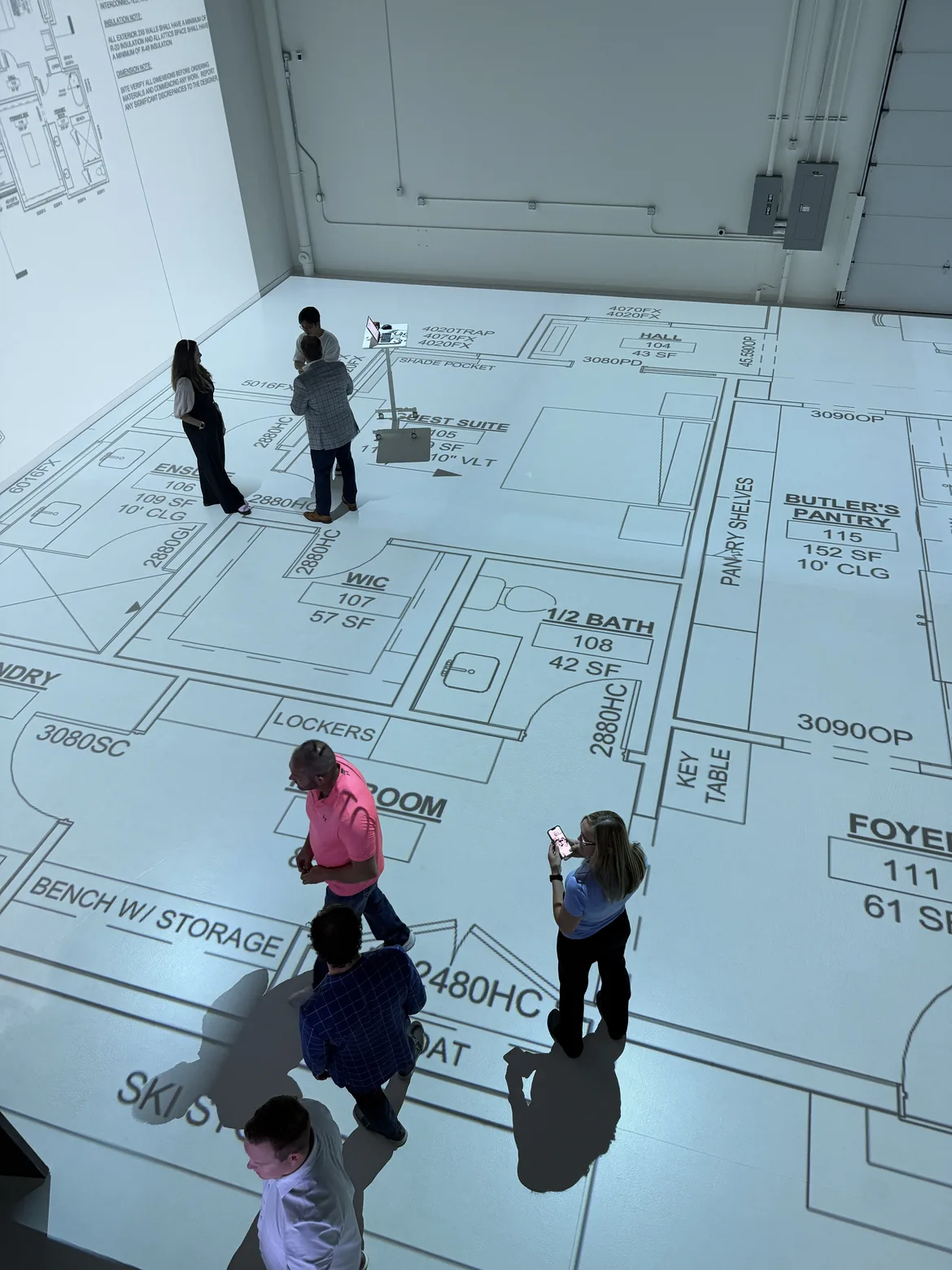 Family walking a life-size floor plan at Walk Your Plans